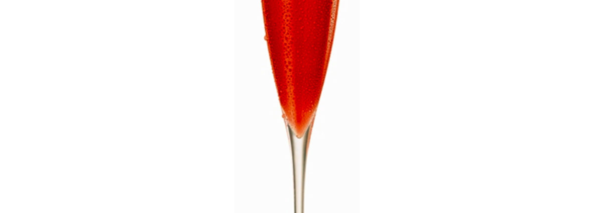 champagne flute with sparking cranberry liquid and floating cranberries