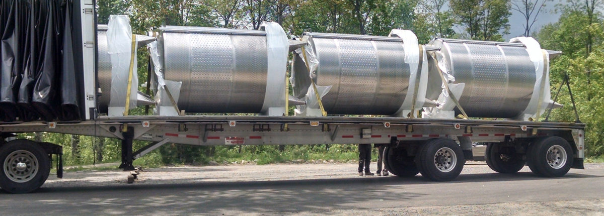 transport truck with four wine tanks on flatbed