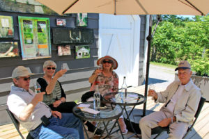 two older couples sampling muskoka lakes wine on the patio