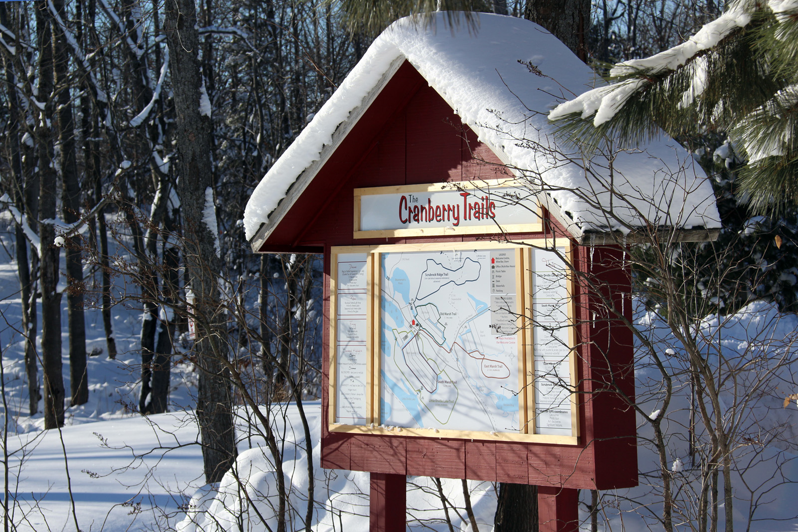 picture of snow covered trail head sign at johnston's cranberry marsh