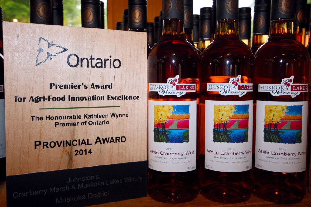 Premier's award for agri-food innovation excellence beside Muskoka Lakes White Cranberry Wine