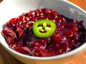 dish of cranberry sauce with hot pepper garnish