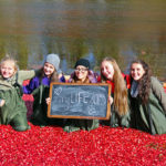 five smiling girls in floating cranberries holding 'my life in 2015' sign