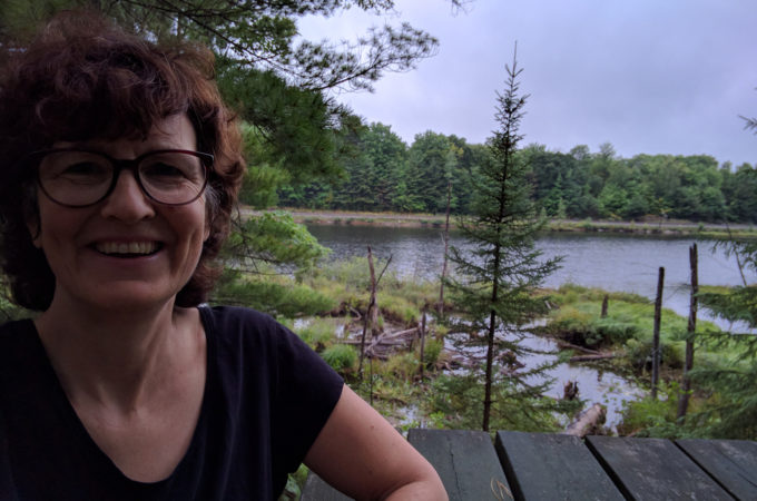 selfie at a picnic table overlooking a lake