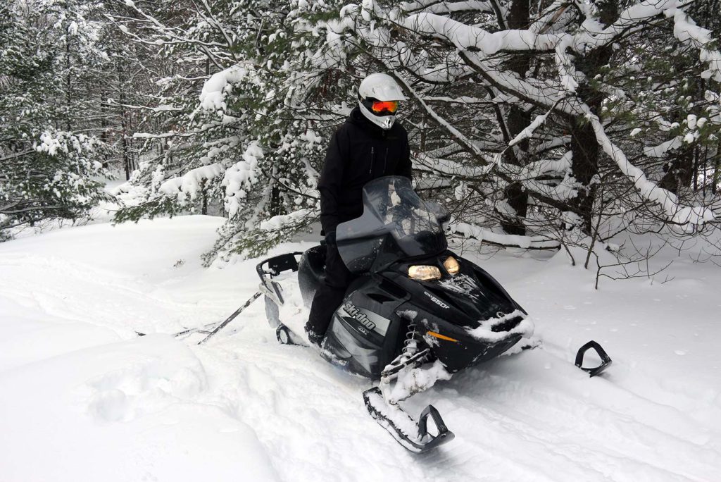 Grooming snowshoe trails with a snowmobile at Johnston's Cranberry Marsh in Bala, Muskoka, Ontario