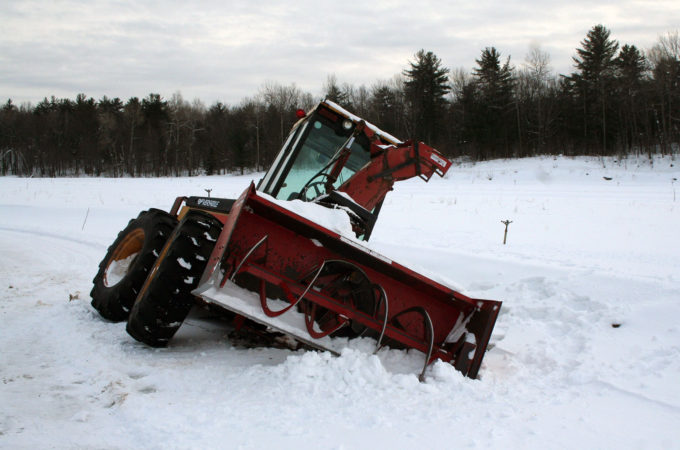 Versatile tractor and snowblower stuck sideways in a ditch