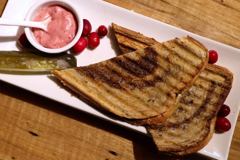 plate with grilled cheese sandwich cranberry mayo and pickle