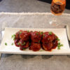 plate of turkey meatballs with cranberry glaze and a glass of muskoka lakes wine