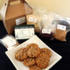 plate of oatmeal cookies with packages of ingredients and a cookie box in the background