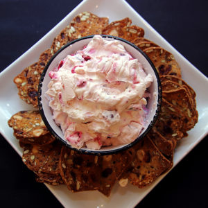 plate with crackers and cranberry jalepeno dip
