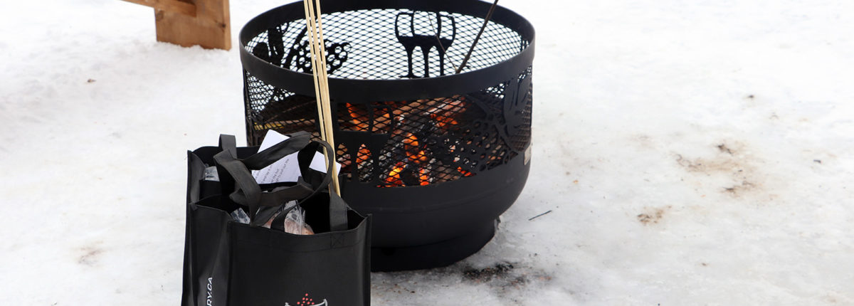 bags of food beside a fire pit
