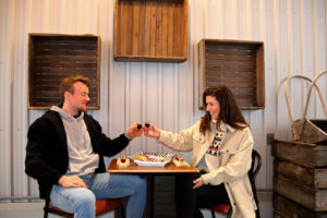 couple toasting with wine and cheese
