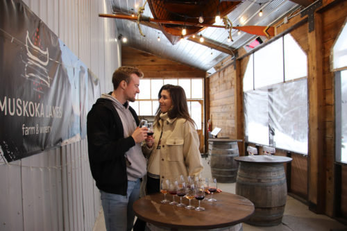 couple tasting wine on a porch