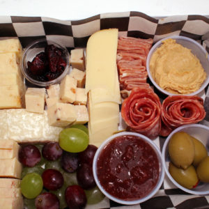 charcuterie box with cheese, meat, crackers