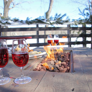 two glasses of wine on an outdoor fire table