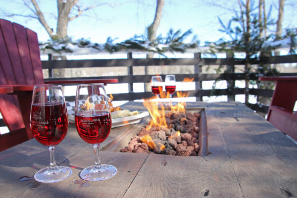 two glasses of wine on an outdoor fire table