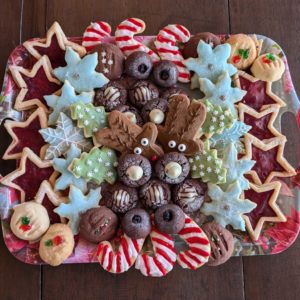 A photo of a festive tray filled with a variety of homemade Christmas cookies.