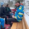 A group of people ride our new sleigh