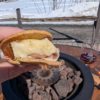 A savory s'more featuring melted brie, prosciutto, and maple caramelized onions